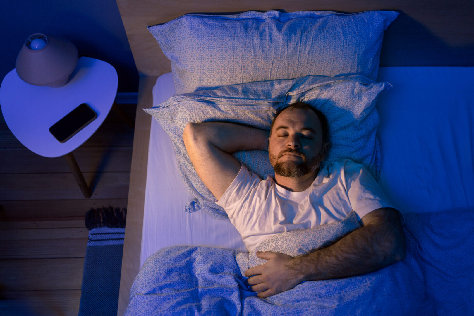 Man peacefully sleeping in a cozy bed