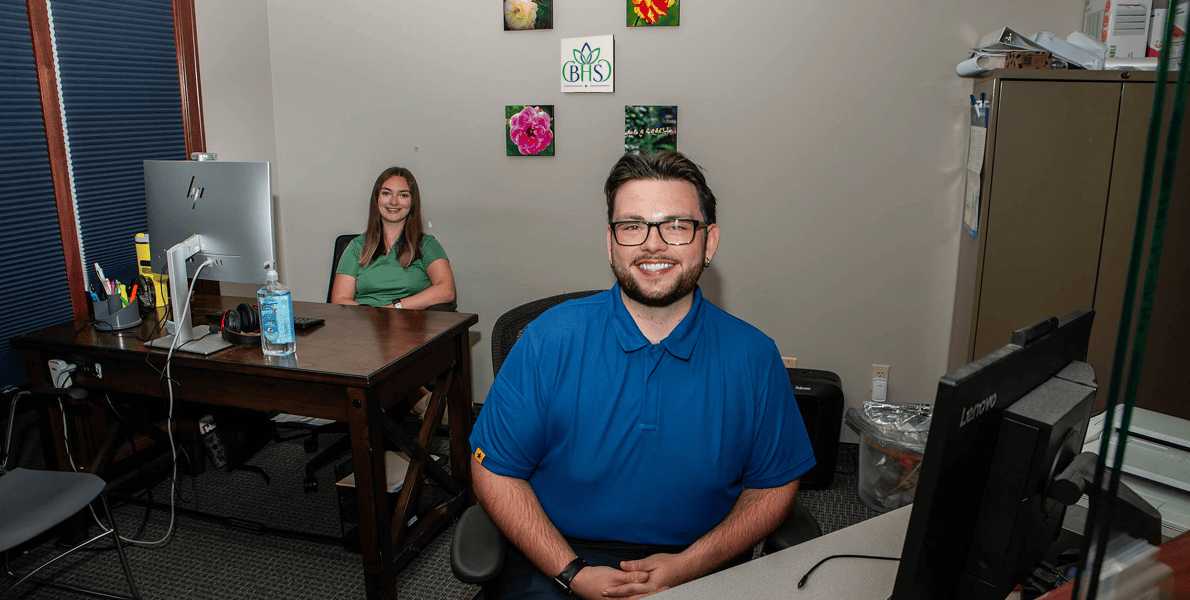 Employee smiling at the desk